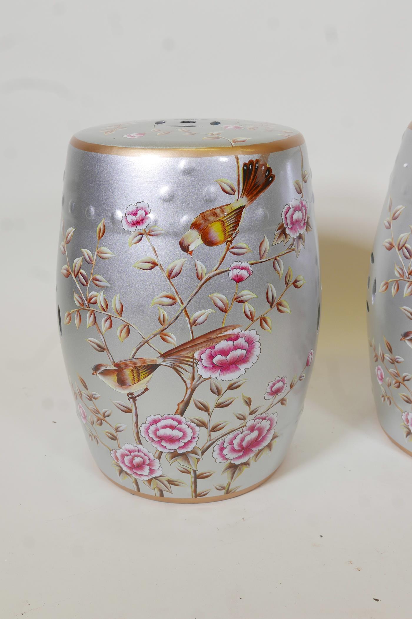 A pair of porcelain garden stools decorated with birds and flowers in bright enamels on a silver - Image 2 of 4