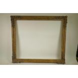 A good mid C20th gilt composition picture frame with flower and scroll decoration, 28½" x 24¼"