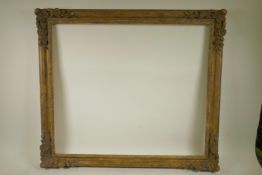 A good mid C20th gilt composition picture frame with flower and scroll decoration, 28½" x 24¼"