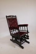 An American mahogany rocking chair, with turned spindles and carved details, A/F
