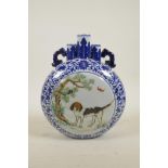 A Chinese blue and white porcelain two handled triple stem moon flask with polychrome decorative