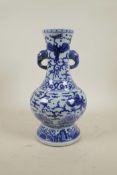 A Chinese Ming style blue and white porcelain two handled vase decorated with dragons and phoenix, 6