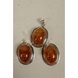 A suite of silver mounted faux amber earrings and pendant