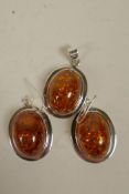 A suite of silver mounted faux amber earrings and pendant