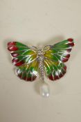 A silver and enamel butterfly pendant brooch with faux pearl drop, 2" wide