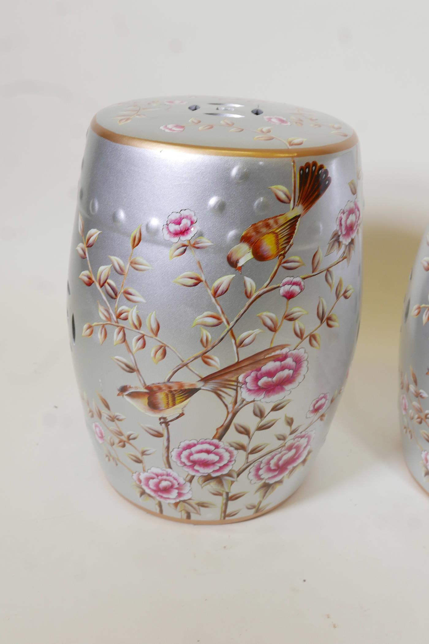 A pair of porcelain garden stools decorated with birds and flowers in bright enamels on a silver - Image 4 of 4