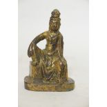 A bronze figure of a seated Buddhistic figure, with worn gilt patination, 5" high