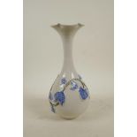A Chinese blue and white porcelain vase with a slender neck and flared rim, the body with raised