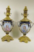 A pair of Continental porcelain and ormolu table lamp bases decorated with cartouches of classical