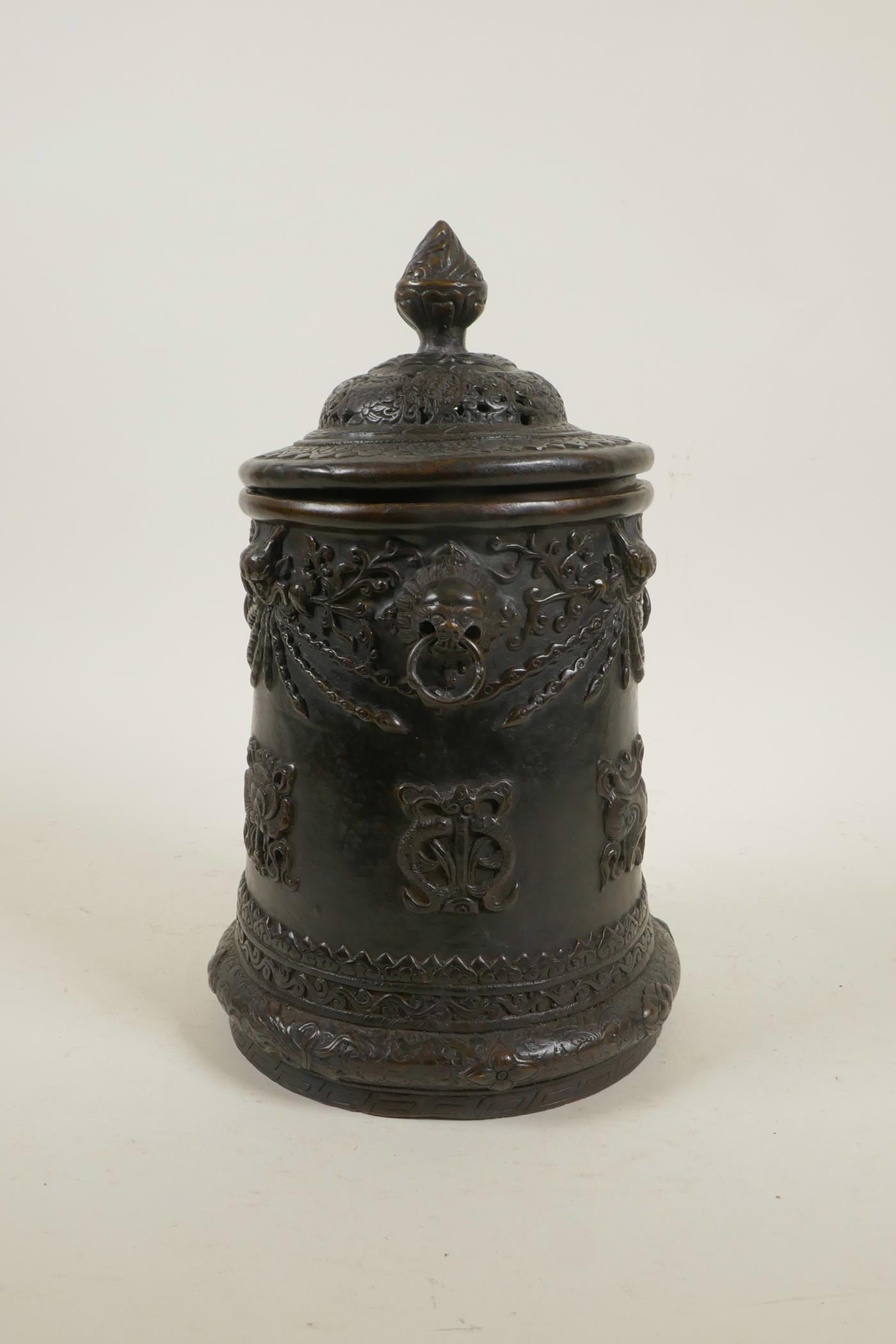 An antique Sino-Tibetan bronze container and cover with three kylin mask handles and decorated - Image 3 of 5