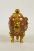 A Peking glass censer and cover on tripod supports with three raised and gilt depictions of Buddha