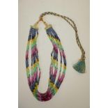 A seven strand ruby, emerald and blue sapphire gemstone necklace, with gold and coloured silk thread