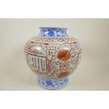 A Chinese porcelain vase with stylised bands of red and blue scrolls and flowers, with panels of