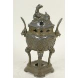 An Oriental bronze censer raised on four kylin headed legs, the body embossed with a phoenix and the