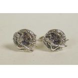 A pair of sterling silver cufflinks decorated with a female nude
