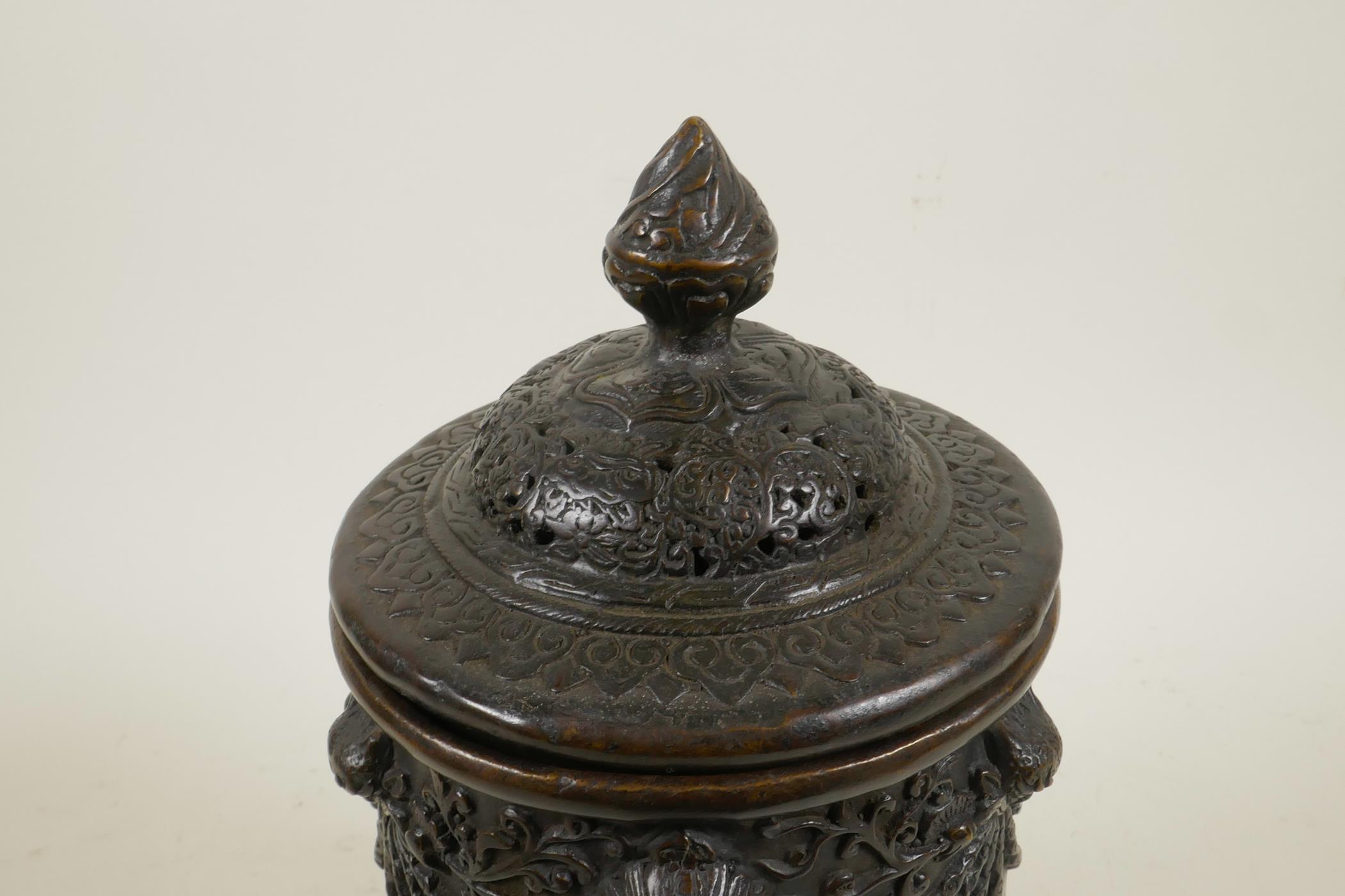 An antique Sino-Tibetan bronze container and cover with three kylin mask handles and decorated - Image 4 of 5