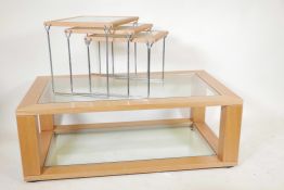 A contemporary golden oak coffee table with a glass inset top and undertier, together with a nest of