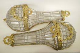 A pair of glass and gilt metal wall lights of classical style, 27" long