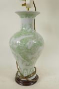 A porcelain table lamp base in the form of a Chinese baluster vase with embossed dragon