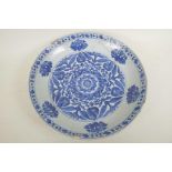 An early C19th Chinese blue and white porcelain charger decorated with lotus flowers and symbols,