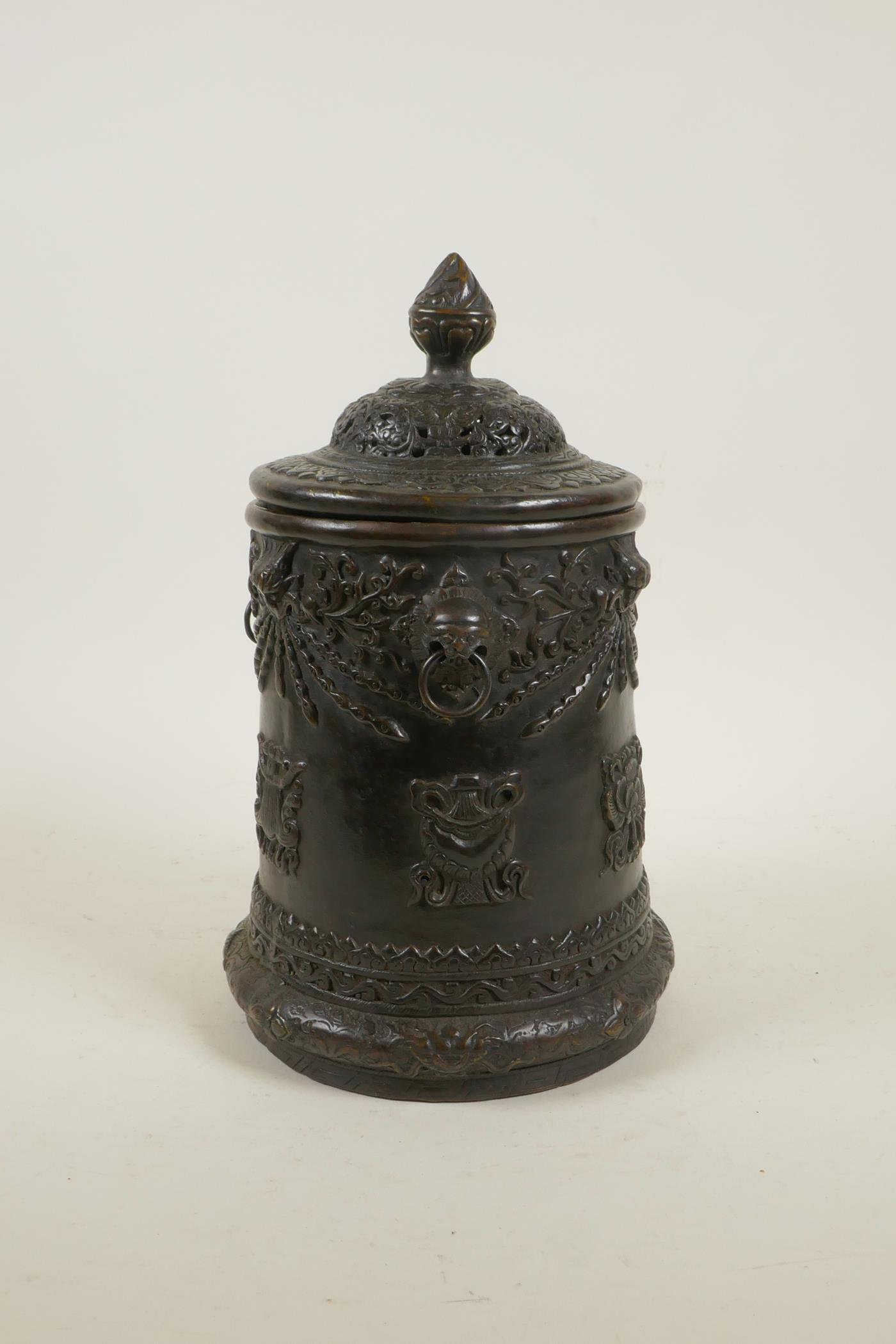 An antique Sino-Tibetan bronze container and cover with three kylin mask handles and decorated - Image 2 of 5