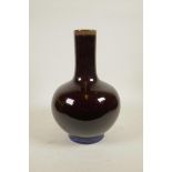 A Chinese burgundy flambe glazed porcelain bottle vase, 4 character mark to base, 13½" high