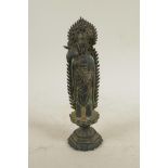A Chinese bronze figure of Quan Yin standing on a lotus throne holding a ruyi, 8½" high