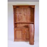 A pine two section dresser, the upper with open shelves, the lower with two cupboards, 42" x 11" x