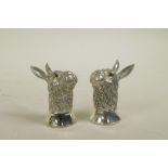 A pair of silver plated condiments in the form of hares, 2½" high
