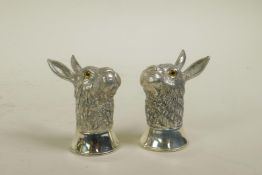 A pair of silver plated condiments in the form of hares, 2½" high