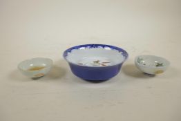 Two Chinese soy cups/saucers decorated with a crane and a tortoise, together with a blue and white