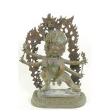 A bronze figure of a warlike Himalayan Buddhist deity, with three faces, six arms and four legs,