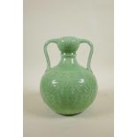 A Chinese green glazed garlic head shaped vase with two handles and underglaze lotus flower