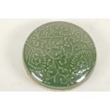 A Chinese green glazed porcelain trinket box with embossed flower decoration (signed), 5" diameter