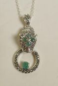 A silver pendant necklace in the form of a jaguar's head, encrusted with marcasite and emeralds,