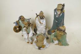 A collection of Chinese Shiwan style figures, including a warrior and travellers, five in total