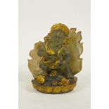 A Tibetan moulded glass figure of a wrathful deity with gilt highlights, 4" high