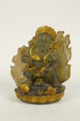 A Tibetan moulded glass figure of a wrathful deity with gilt highlights, 4" high