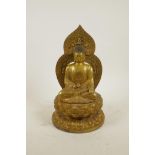 A Chinese gilt bronze figure of Buddha seated on a lotus throne, impressed 4 character mark to base,