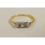 An 18ct gold three stone diamond ring, approximate size 'L/M'