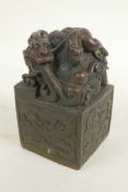 A Chinese bronze seal, the top and sides decorated with dragons, 5" high