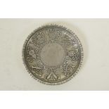 A Chinese white metal coin dish decorated with the emblems of the Eight Immortals, 3½" diameter