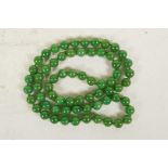 A string of apple green jade beads, 32" long