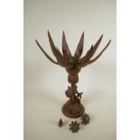An oriental mid C20th wooden lotus flower metamorphic table lamp, with carved floral base and double