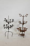 A wrought iron eight branch candelabra with trailing leaf decoration, together with a thirteen