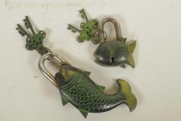 A bronze padlock in the form of a carp and another smaller, the keys with vajra decoration, 7" long