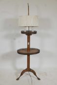 A mahogany lamp table with pierced galleries, raised on tripod supports, 55" high, A/F
