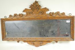 A C19th satin walnut framed wall mirror with carved and pierced crest, 36" x 24"