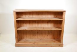 A pine open bookshelf with three shelves, on a plinth base, 51" x 11½", 38" high