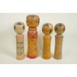 Four Japanese turned and painted wood Kokeshi dolls, largest 12" high